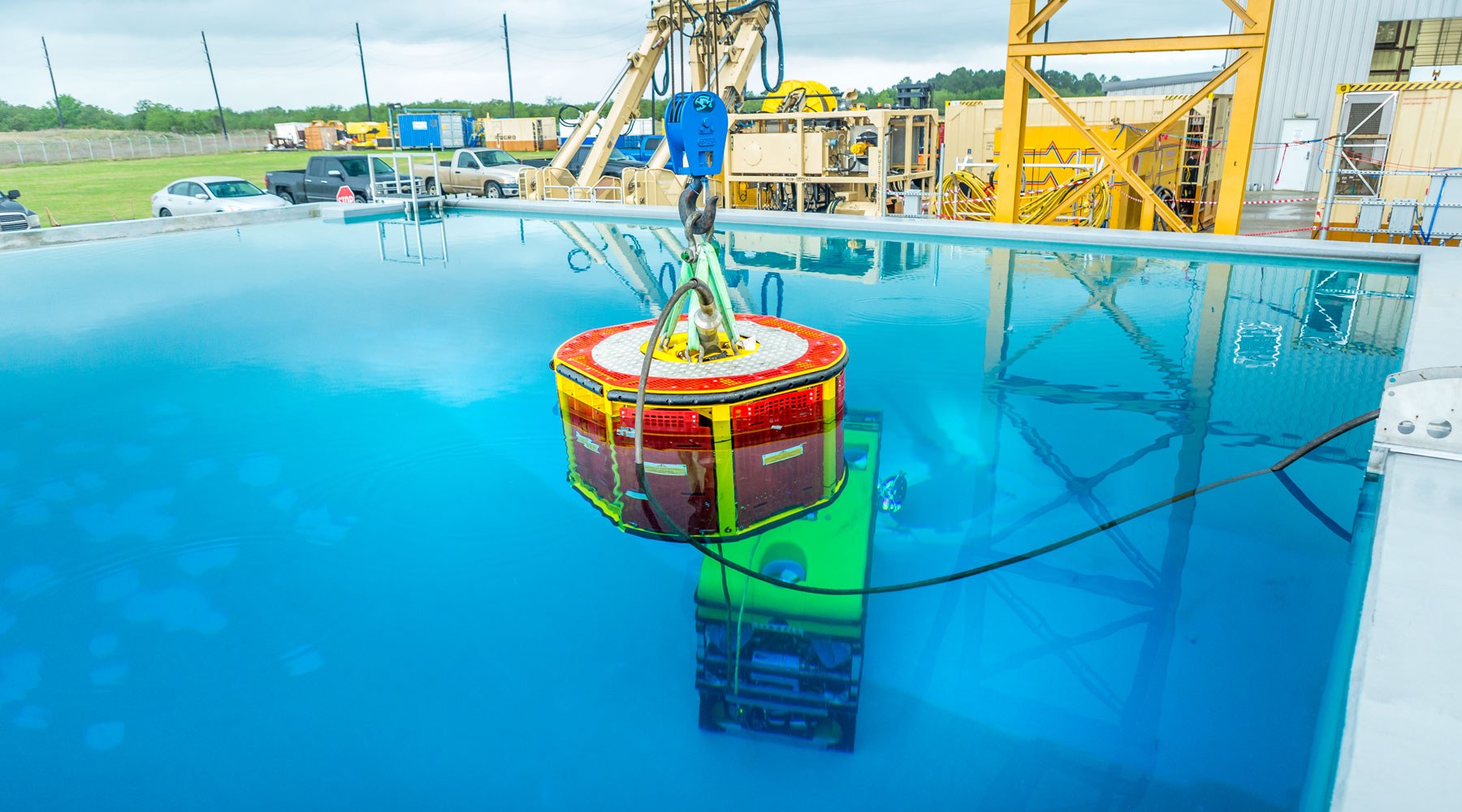 A piece of subsea equipment being tested in a tank of water A piece of subsea equipment being tested in a tank of water