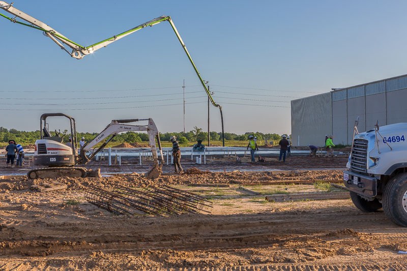 Image of several people on a construction zone with a white differ in the mid-ground