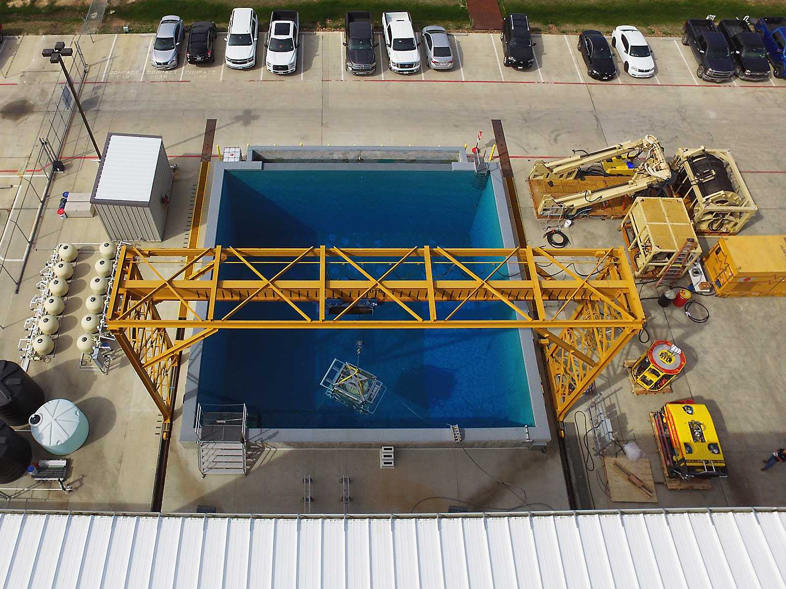 Aerial image of large tank of water with yellow arch over top of it