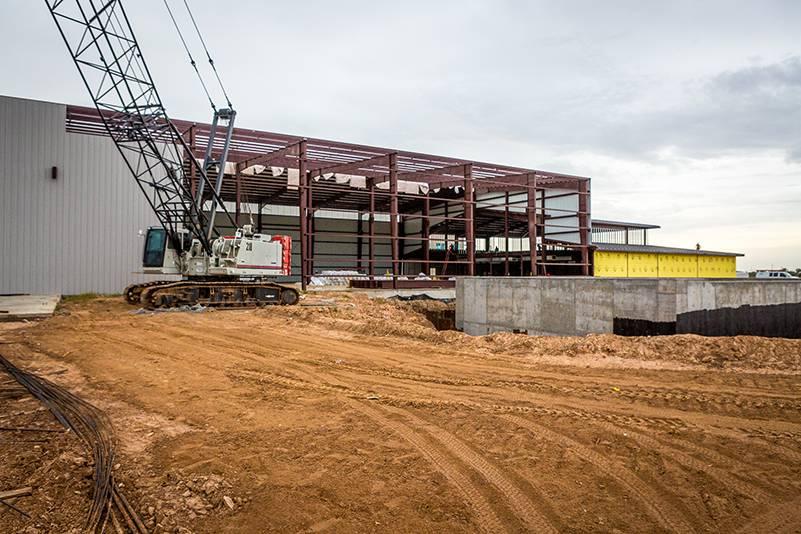 Image of a building under construction with a crane in front of it