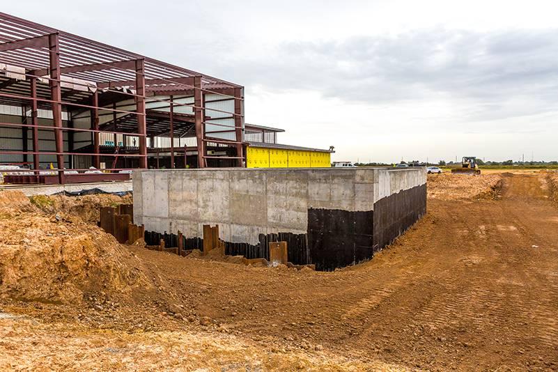 Image of a square concrete structure outside of a building under construction